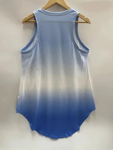 Detail of blue and white gradient sleeveless mini dress with racerback and curved hem