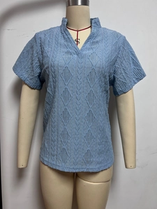 Short sleeve light blue V-neck blouse featuring intricate geometric hollow lace pattern