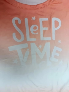 Close-up of 'SLEEP TIME' text and star pattern on orange gradient summer mini dress