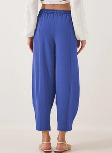 Detail view of high waist drawstring trousers with vertical stitching and natural texture