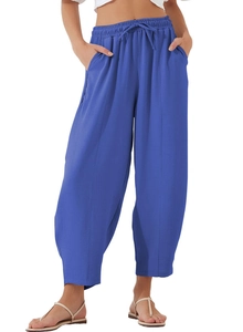 Detail of high waist royal blue casual pants showing drawstring elastic waistband and pockets