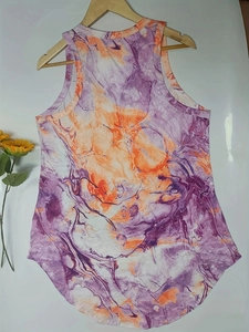 Detail of summer sleeveless mini dress featuring purple and orange marble tie-dye pattern