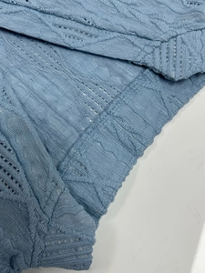 Women's V-neck short sleeve shirt in light blue jacquard knit fabric with hollow details