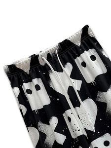 Detail of the elastic waistband and white drawstring on graffiti print wide leg pants