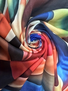 Plus size maxi dress with colorful wave print and soft knitted texture in spiral view