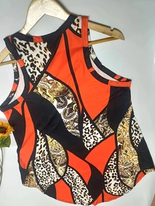 Detail of summer sleeveless tank top with leopard print and orange paisley pattern