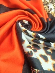 Detailed view of the leopard print fabric with orange and black color block textures