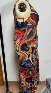 Detail shot of sleeveless maxi dress featuring vibrant abstract swirl print patterns