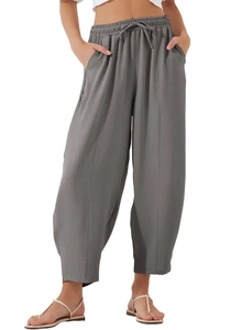 Detail of high waist elastic drawstring waistband and side pockets on dark grey harem pants