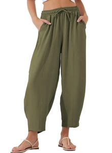 Detail view of olive green drawstring waist pants with pockets and breathable fabric texture