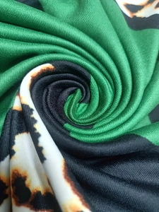 Detailed macro view of high-elasticity knit fabric with green and leopard 3D print texture