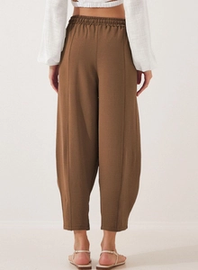 Detail view of coffee brown cotton linen trousers with elastic high waist and pockets