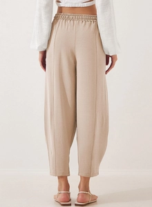 Detailed back view of high-waist loose trousers showing textured fabric and drawstring