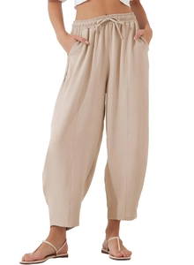 Detail of high waist elastic drawstring waistband on beige loose cotton linen pants