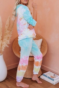 Detail of tie-dye gradient loungewear set featuring drawstring hoodie and ribbed cuffs