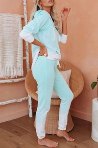 Detail of mint green and white color-block loungewear set with hoodie and joggers