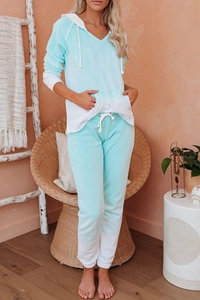 Close-up of ombre blue tie-dye knit lounge set featuring hooded V-neck and drawstring