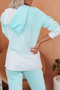 Detail view of mint green and white color-block hoodie set from a back perspective