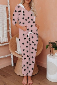 Detailed view of pink hooded loungewear featuring black heart patterns and white drawstrings