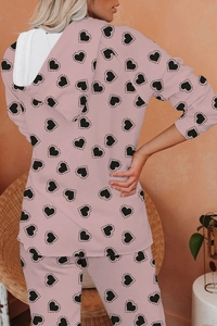 Rear view of pink long-sleeve hooded pajamas set featuring black heart print patterns