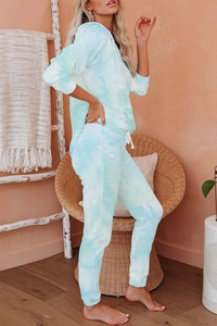 Detail of light blue tie-dye knit lounge set featuring hooded sweatshirt and joggers