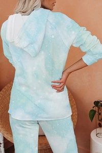 Detail of blue and white tie-dye loungewear set showing the hoodie back and soft texture