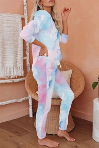 Detail view of tie-dye knit loungewear set with pastel blue and pink cloud patterns