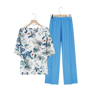 Women's two-piece casual set featuring floral print short sleeve top and blue wide-leg pants