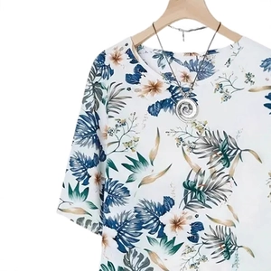 White tropical print short sleeve top with floral pattern and silver necklace detail
