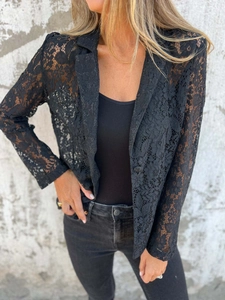 Detail shot of sheer black lace blazer featuring floral patterns and classic notched lapels