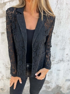 Close-up of elegant black lace blazer featuring intricate crochet patterns and tailored fit