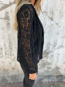 Detailed view of the sheer floral lace texture on this black tailored blazer jacket