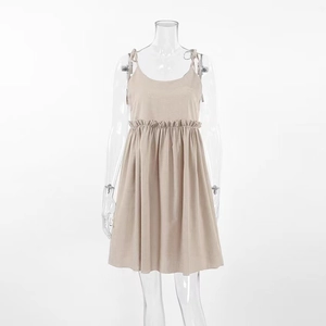 Detail view of khaki summer dress showing adjustable shoulder ties and ruffle waist seam