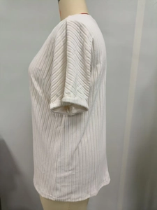 Detail view of white short-sleeved T-shirt showing vertical pleated texture and cuffed sleeves