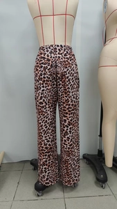 Detail view of high-waist leopard print wide-leg trousers with elastic waistband