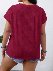 Back view of a wine red short-sleeved women's T-shirt with textured waffle knit fabric