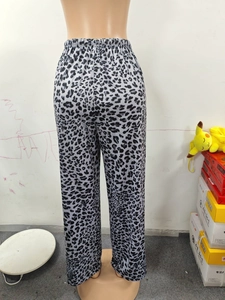 Close-up of leopard print wide-leg trousers featuring elastic waistband and soft fabric
