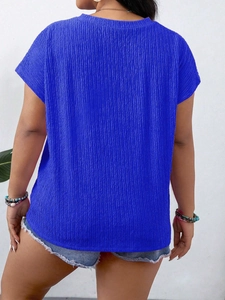 Back view of royal blue short sleeve top featuring unique pleated texture and round neck