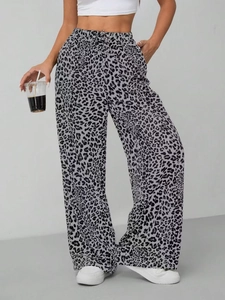 Detail of high-waist leopard print wide-leg trousers with adjustable drawstring waist