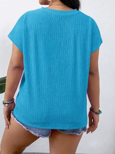 Detail of bright blue round neck tee with vertical pleated texture and flutter sleeves