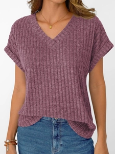 Detail of ribbed knit texture on a lavender V-neck short sleeve top with rolled cuffs