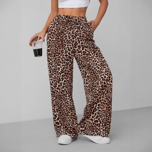 Women's leopard print wide-leg trousers with adjustable drawstring waist and casual pockets