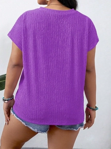 Detail view of purple crew neck top with vertical pleated texture and flutter sleeves