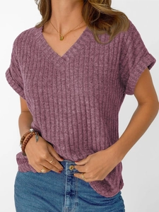 Close-up of purple V-neck knit T-shirt featuring fine ribbed texture and rolled sleeves