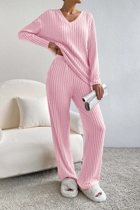 Detailed macro view of the soft pink ribbed knit fabric texture on the V-neck knit set