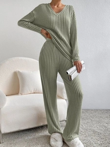 Detailed texture of sage green knit lounge set with vertical ribbed pattern and V-neckline