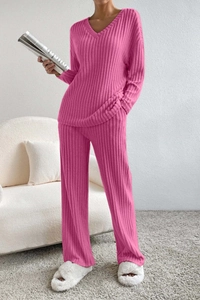 Detail of soft ribbed knit texture on women's V-neck top and wide-leg trousers set