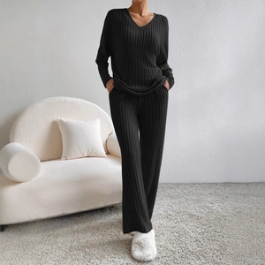 Women's two-piece black ribbed knit lounge set featuring a V-neck top and straight pants
