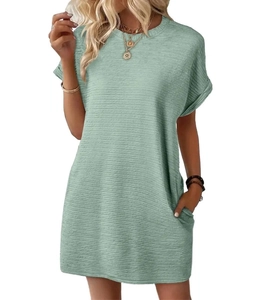 Detail of light green summer dress showing textured puckered fabric and side pockets