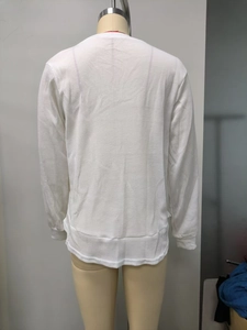 Detail view of white waffle knit sweatshirt showing fabric texture and back fit